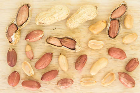 peanut pile top view on wooden background