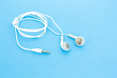 earbuds or earphones on blue backgroundの写真素材