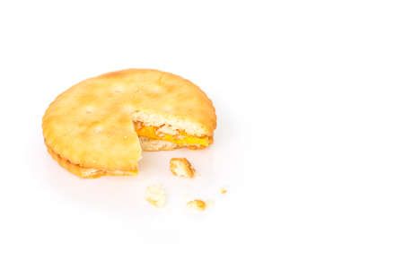 single cracker square broken on white background.