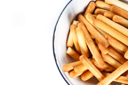 bread sticks top view on plate on white background.の写真素材