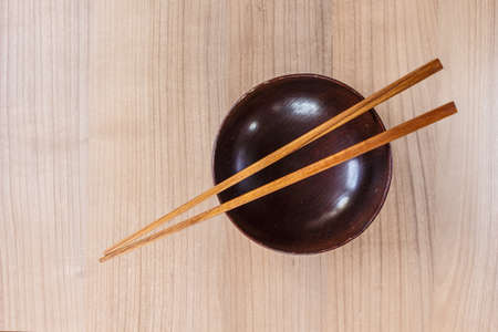 bowl and chopsticks wooden top view on table wooden.の写真素材