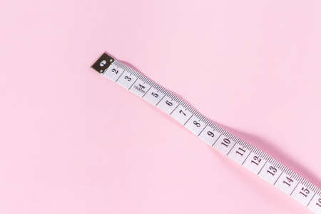 measure tape tool of sewing work on pink background.の写真素材