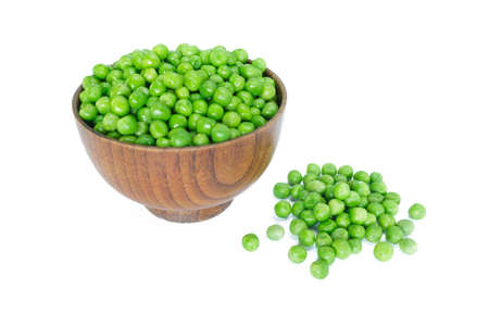 green peas on wooden bowl on white background.の写真素材