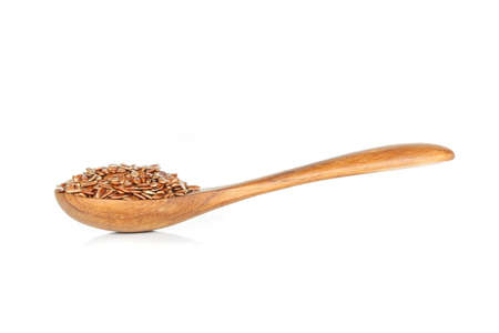 Brown flax seed in spoon on white background.の写真素材