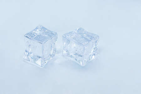 Ice cubes on light blue background.の写真素材