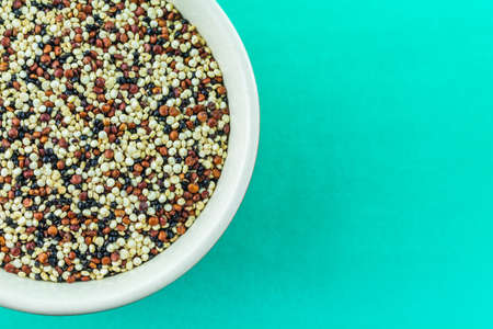 quinoa beans in bowl on green background.の写真素材