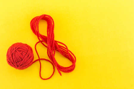 yarn color red on yellow background.の写真素材