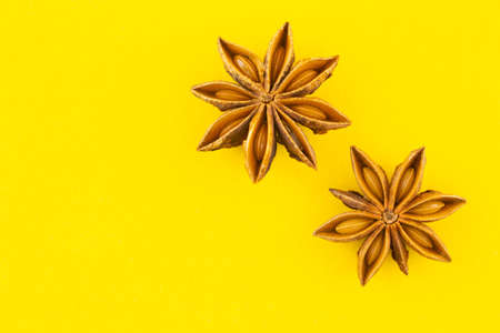 heap star anise top view on yellow background.の写真素材
