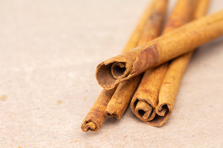 cinnamon on brown paper background front view close up.の写真素材