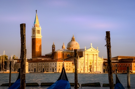 Gondolas moored by Saint Mark square with San Giorgio di Maggiore church background at sunset in Venice, Italy.の写真素材