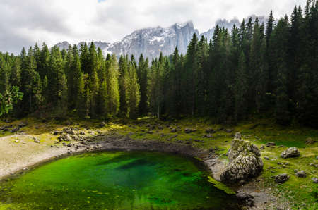 Beautiful view of famous Carezza lake at dolomite mountain, Italy.