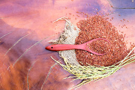 rice berry in wicker container on hemp and wooden backgroundの写真素材