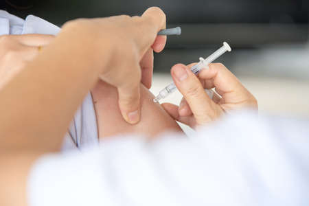 doctor maksd vaccinating to patientの写真素材