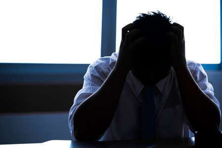 silhouette businessmen  and busy work, serious worker manの写真素材