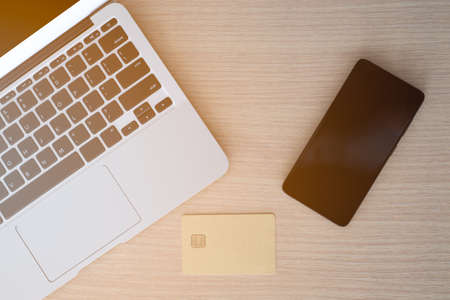 top view office desk, smartphone and credit card and laptop on office work desk