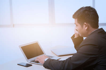 young business man typing laptop, office man workingの写真素材