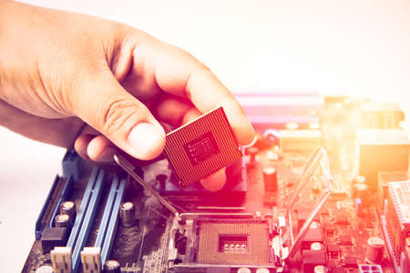 center of CPU, macro photography of cpu unit,man fixing computer by putting CPU on socketの写真素材