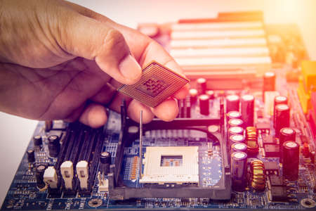 center of CPU, macro photography of cpu unit,man fixing computer by putting CPU on socketの写真素材