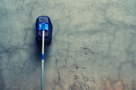 mop holding on wallの写真素材