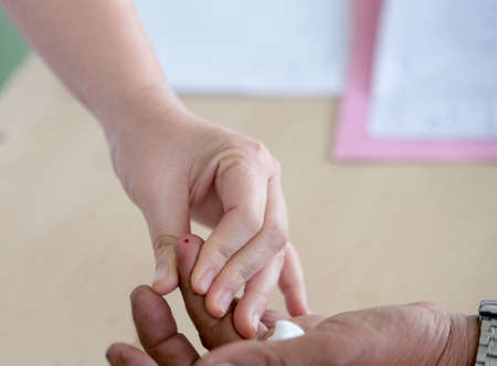 doctor testing diabetes blood sugar, finger test, fasting blood sugarの写真素材