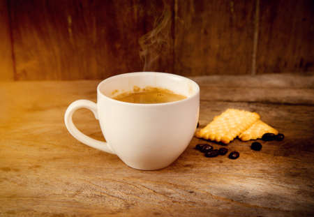 coffee cup with crackle food on wooden backgroundの写真素材