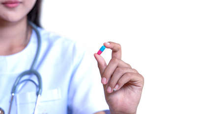 doctor holding capsule medication on white backgroundの写真素材