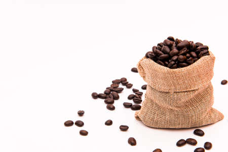 coffee beans in burlap on white backgroundの写真素材