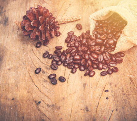 coffee bean in burlap on wooden tableの写真素材