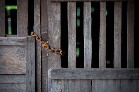 rust imprisonment chain with old wooden doorの写真素材