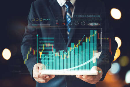 businessman white suit present information chart of stock investingの写真素材