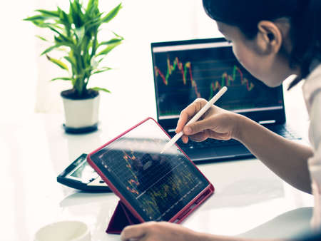 business woman trading forex stock, trading forex in tablet platform and destopの写真素材