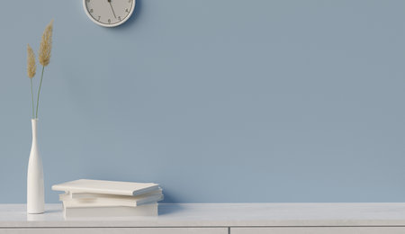 Blue wall with white book on table, copy space for text design, 3D illustrations renderingの写真素材