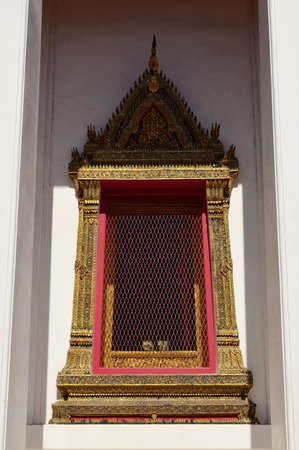 Ancient golden window of Thai templeの写真素材