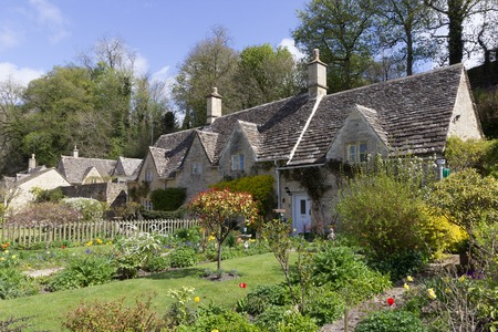 A row of picturesque, historic cottages in the village of Bibury, in the Cotswolds, UK 