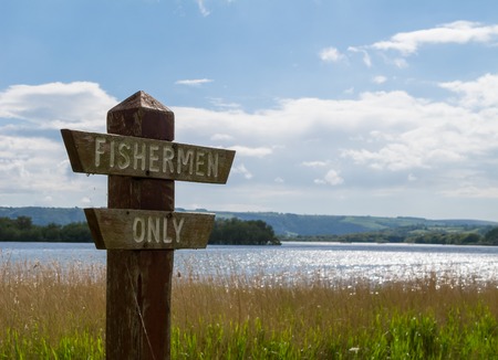 Fishermen Only Sign, with Chew Valley Lake  in the background 
