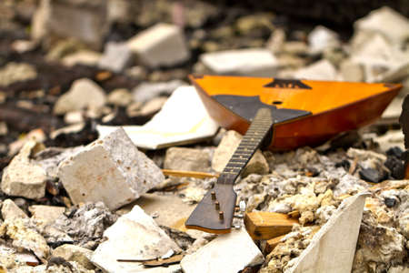 Balalaika on the ruins of a destroyed old buildingの写真素材