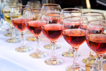 glasses of white and red wineの写真素材