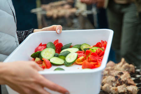 Fresh vegetables in box in hands outdoorsの写真素材