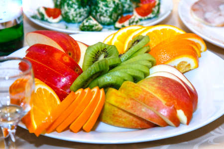 Sliced apples, oranges on a banquet tableの写真素材