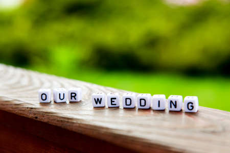 The inscription of the cubes our weddimg on a wooden tableの写真素材