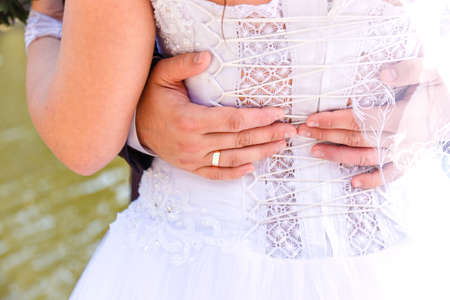 grooms hands on the back of the brideの写真素材