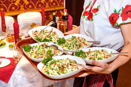 Five tables of salad in female handsの写真素材