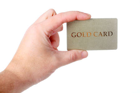 male hand holding gold credit card isolated on white backgroundの写真素材
