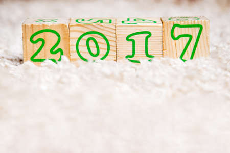 The inscription 2017 made of wooden cubes lying on terry carpet. copy spaceの写真素材