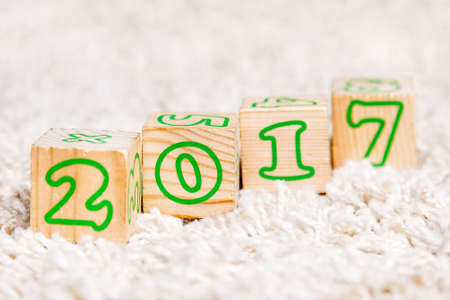 The inscription 2017 made of wooden cubes lying on terry carpetの写真素材