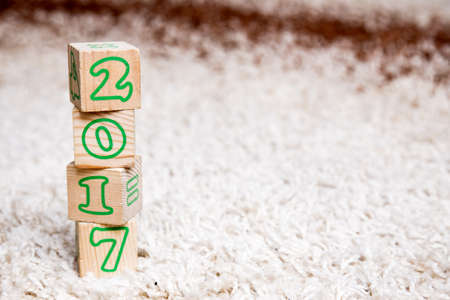 The inscription 2017 made of wooden cubes lying on terry carpetの写真素材