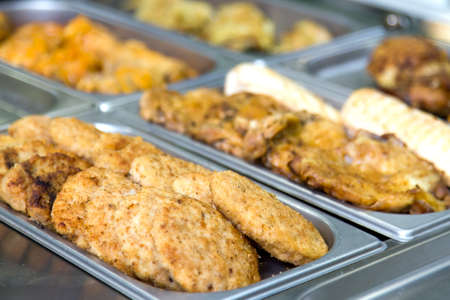 Meatballs and meat dishes at the buffet on metal plates. selective focus