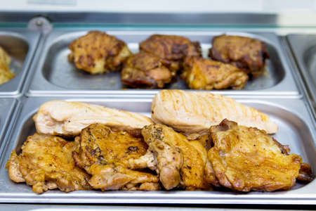 Fried chicken pieces at the buffet on metal plates. selective focusの写真素材