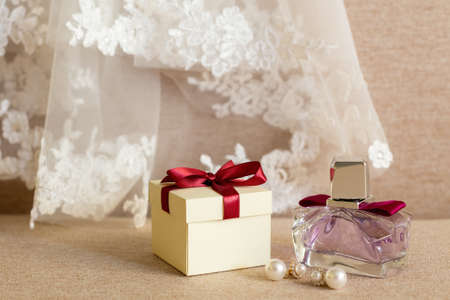 Gift box, earrings, perfume, and the veil of the bride close-upの写真素材