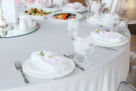 restaurant table with empty glasses and a plate with a napkin close up